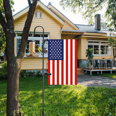 Akeydeco Garden Flag Stand in garden setting with seasonal flags