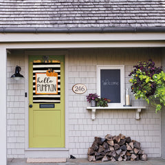 AVOIN colorlife Hello Pumpkin Fall House Flag displayed in a garden