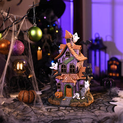 Back view of Valery Madelyn Halloween Village House with color-changing LED lights
