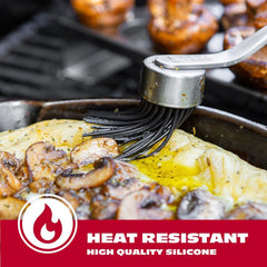 BBQ-Aid basting brush on a grill with barbecue sauce