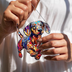 BOYESE Dachshund Ornament hanging near a bright window