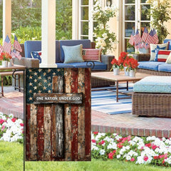 Brightly coloured patriotic flag displayed in a garden