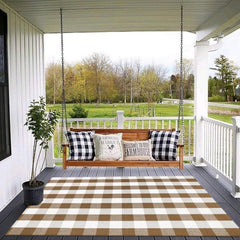 CAINANEL Buffalo Plaid Outdoor Rug layered with a welcome mat on a porch