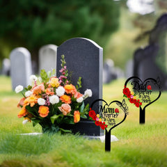 Close-up of the word 'Mom' on the heart-shaped memorial plaque