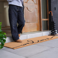 Close-up of THEODORE MAGNUS Welcome Mat texture showing coir fiber