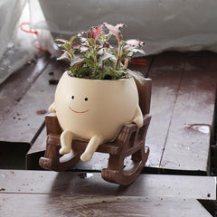 Close-up of UMESONG Smiling Face Planter Pot drainage holes
