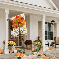 CROWNED BEAUTY Fall Tree House Flag displayed in a garden setting