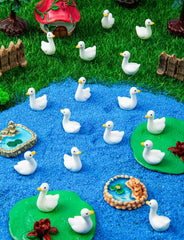 Display of LHSYFBZ Mini Resin Goose Figurines in a garden setting
