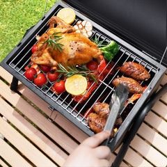 DNKMOR Portable Charcoal Grill with thermometer on lid