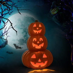 Evelyne pumpkin tower on a porch tabletop during Halloween