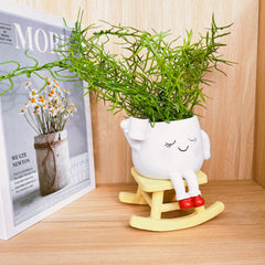 EylbKey Cute Rocking Chair Head Planter on a table with accessories