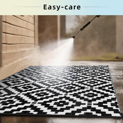 Favoyard Outdoor Rug 6x9 ft showing waterproof feature during cleaning