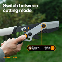 Fiskars 32-inch Lopper in use cutting through a thick branch