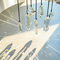 Flat lay of HDCRYSTALGIFTS Clear Crystal Prisms with cords and hooks