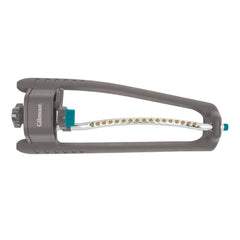 GILMOUR Adjustable Lawn Sprinkler attached to a garden hose