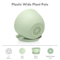Green Meowell flower pot with saucer on a garden table