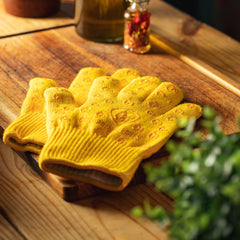 Grill Armor Gloves holding a cast iron skillet