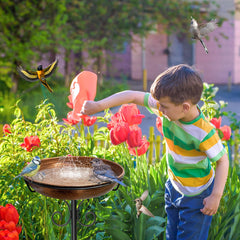 iCHKED bird bath with 5-pronged base in garden setting