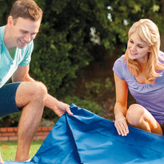 Intex pool cover laid over a metal frame pool