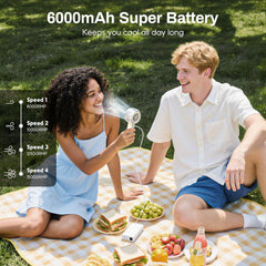 MACMORE handheld fan in use at the beach