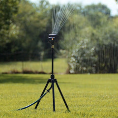 Melnor MiniMax Turbo Oscillating Sprinkler in a garden setting watering plants