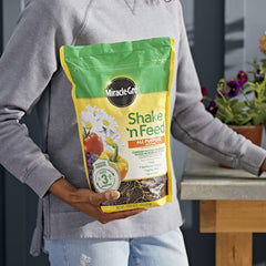 Miracle-Gro Shake 'N Feed in garden with vibrant plants