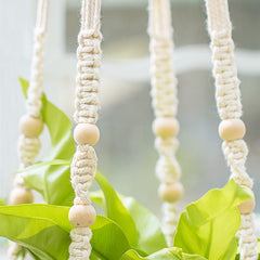 Mkono macrame hanger showcased outdoors on a balcony