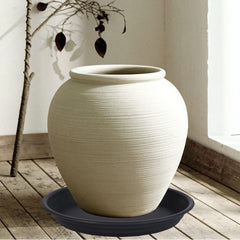 MSKIAUO plant saucer in outdoor garden setting