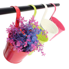 Multicolor flower pots hanging on a balcony railing