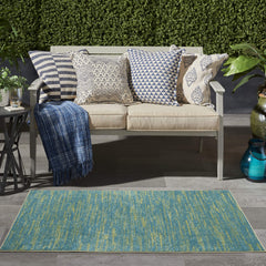Nourison Essentials Blue Green area rug on patio
