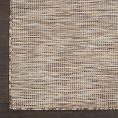 Nourison Positano Beige rug in a patio setting