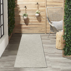 Nourison Positano Light Grey rug displayed on patio