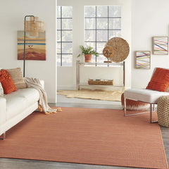 Nourison Positano Terracotta Outdoor Runner Rug in a patio setting