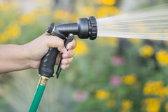 Orbit Front Trigger Nozzle in use watering plants in a garden