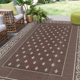 Pauwer Outdoor Rug 6x9 bordered brown front view