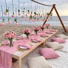 Pink table runners and napkins on a picnic blanket