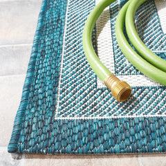 SAFAVIEH Outdoor Rug displayed on a patio setting