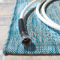 SAFAVIEH washable rug positioned on a patio