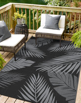 sarben 8'x10' outdoor rug with palm leaf design in black and grey