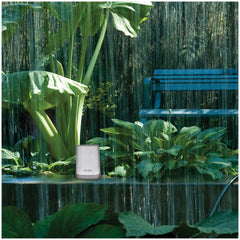 Self-emptying rain collector of AcuRite rain gauge in garden setting