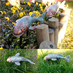 Set of 2 VKEVOC koi fish statues displayed in a garden