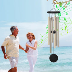 SIONMYTF wind chimes hanging in a garden setting