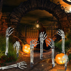 Skeleton arm stake inserted in grass for Halloween decoration