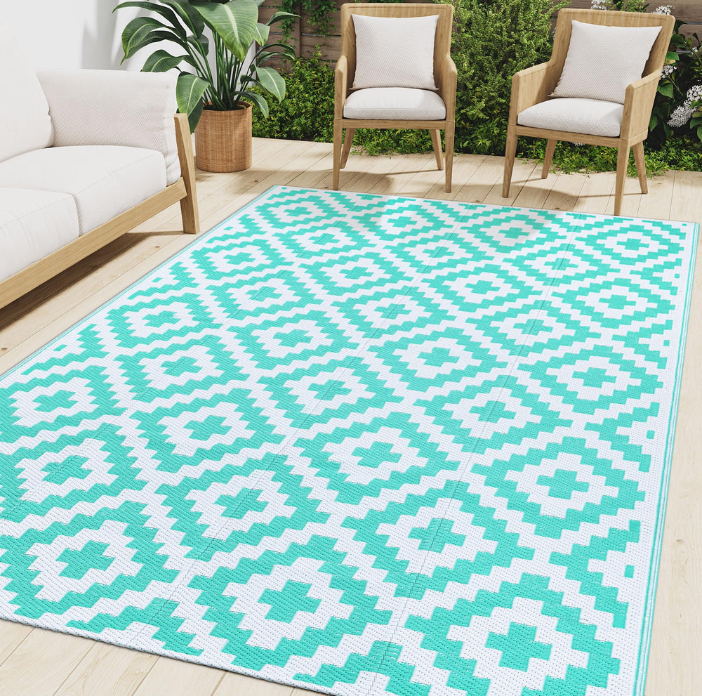 Smiry Outdoor Rug 6x9 ft in white and teal geometric pattern