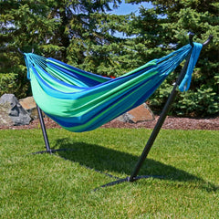Sunnydaze Brazilian Double Hammock set up between trees in a park
