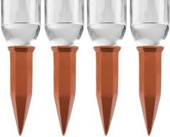 Terracotta self-watering stake inserted in a plant soil
