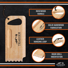 Traeger Wooden Grill Scraper in use on grill grates