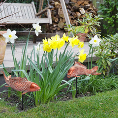 Two Wosuine Koi Fish Statues displayed in a garden setting