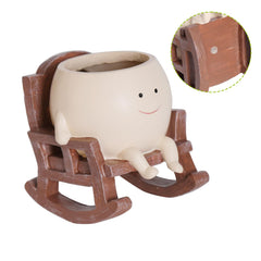 UMESONG Smiling Face Planter Pot in a garden setting