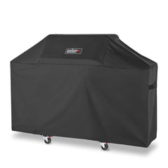 Weber Premium Grill Cover laid over Genesis grill